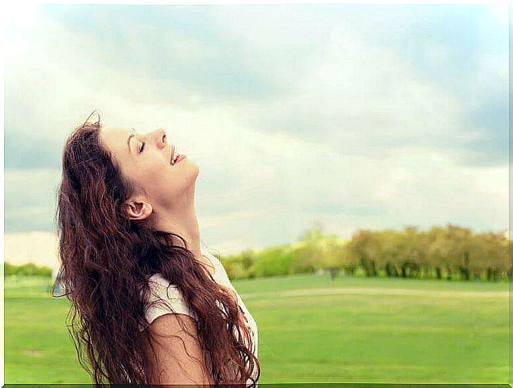 Woman with closed eyes is grateful and can make herself happy because of it.