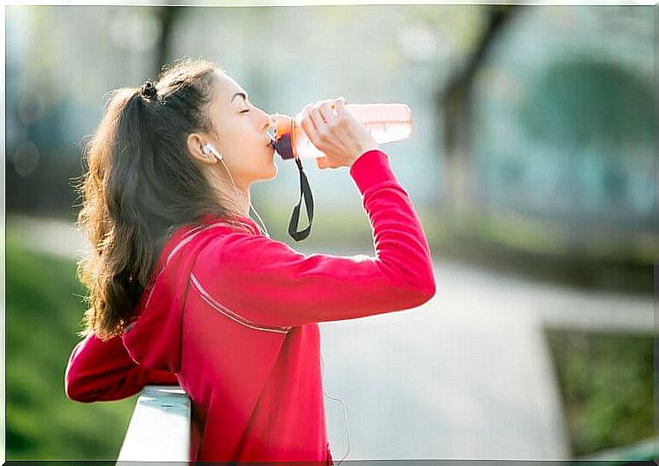 Woman drinks isotonic drink that can increase blood pressure