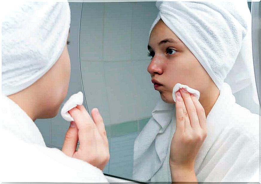 Facial cleaning with apple cider vinegar - woman in front of the mirror