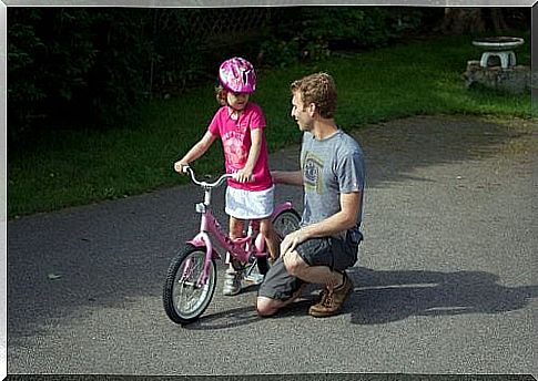 Father and daughter with bicycle